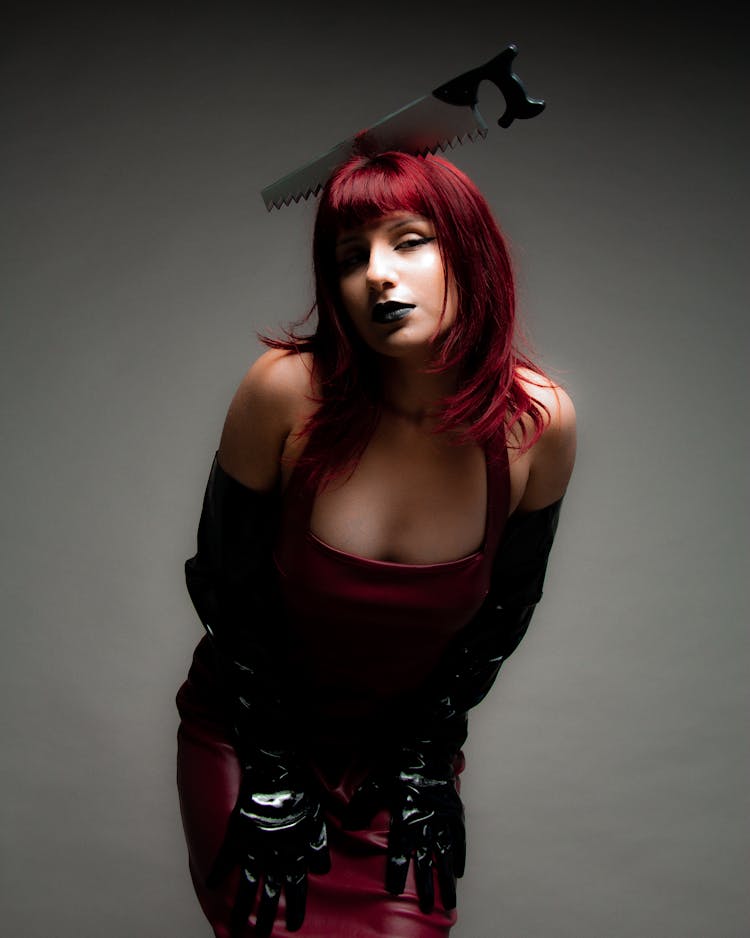 Woman In Creepy Halloween Costume With Saw On Head