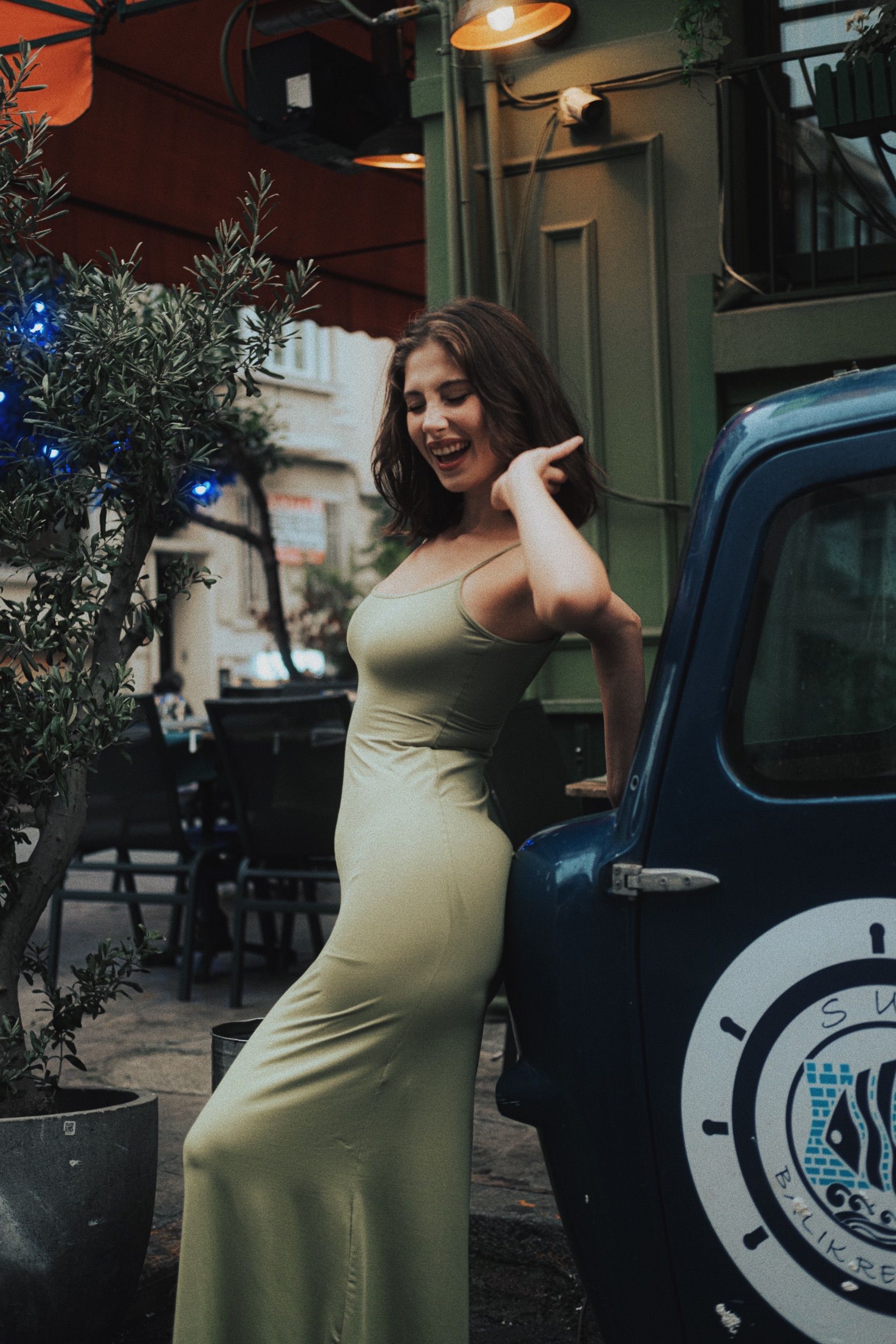 Cheerful Brunette in Long Green Dress · Free Stock Photo
