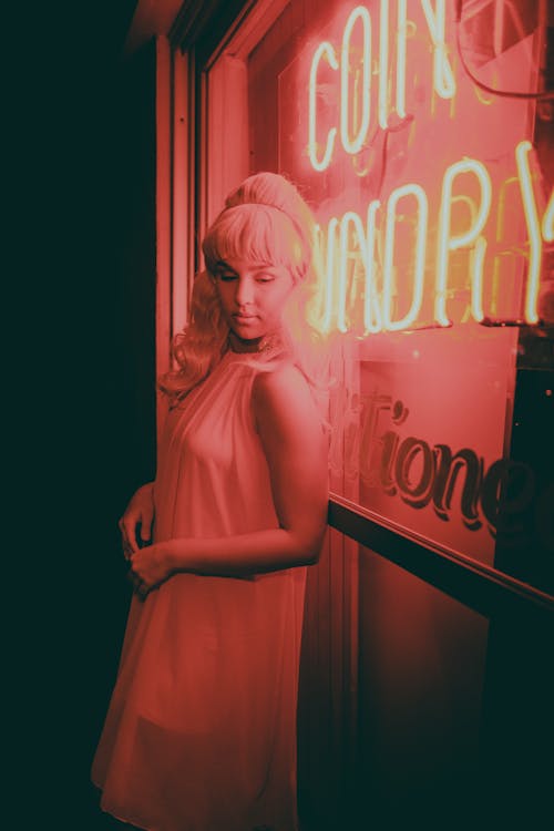 Woman Standing in Front of a Neon 