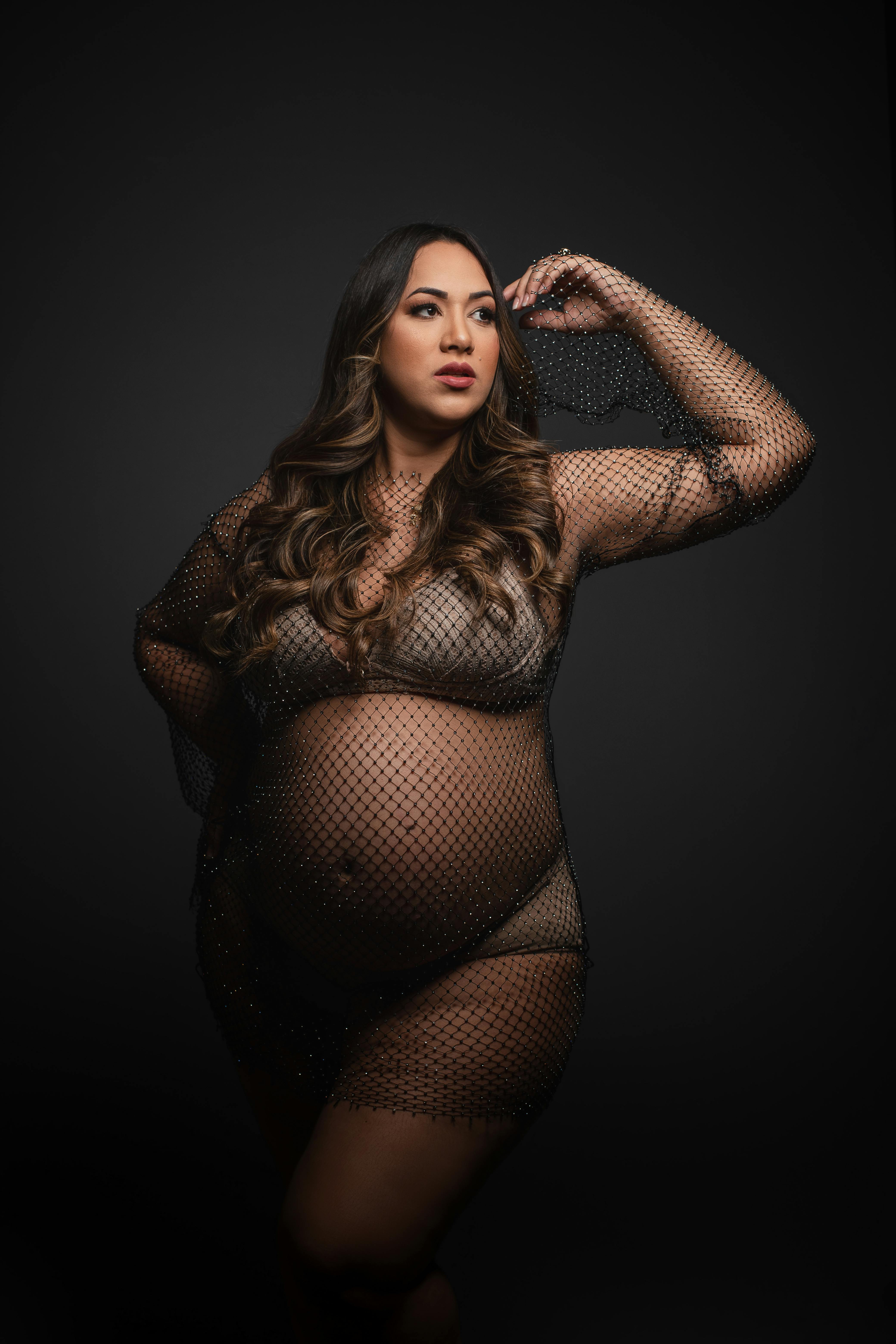 pregnant woman in fishnet lingerie