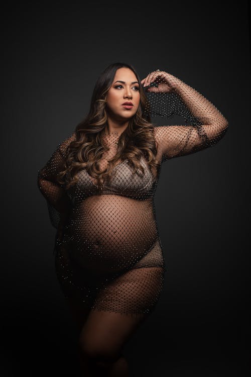 Pregnant Woman in Fishnet Lingerie