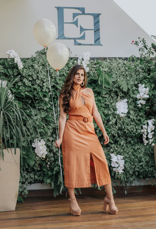 Free Standing Woman While Holding Two Balloons Stock Photo