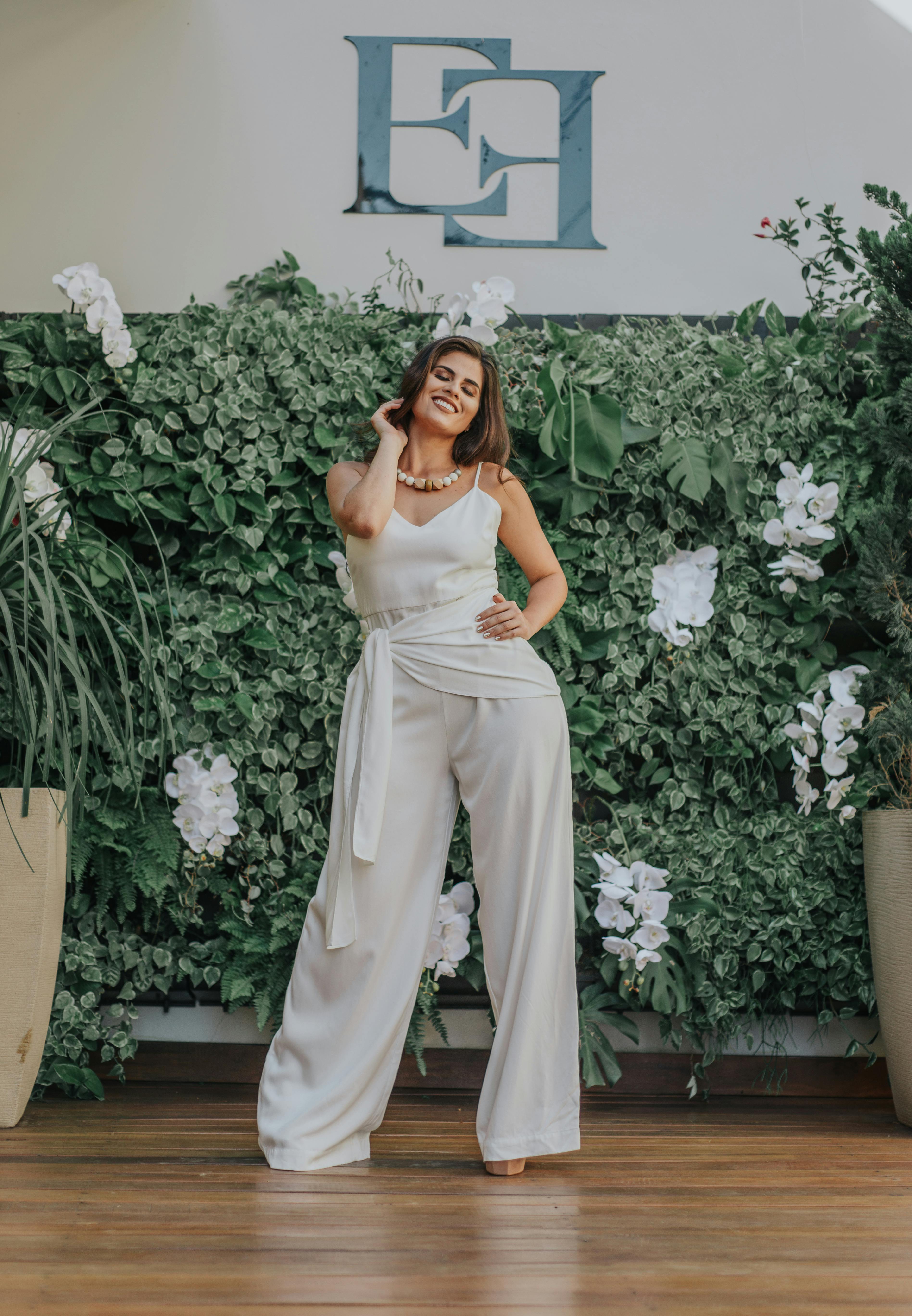 Free Woman Standing In Front Of Leaves Stock Photo