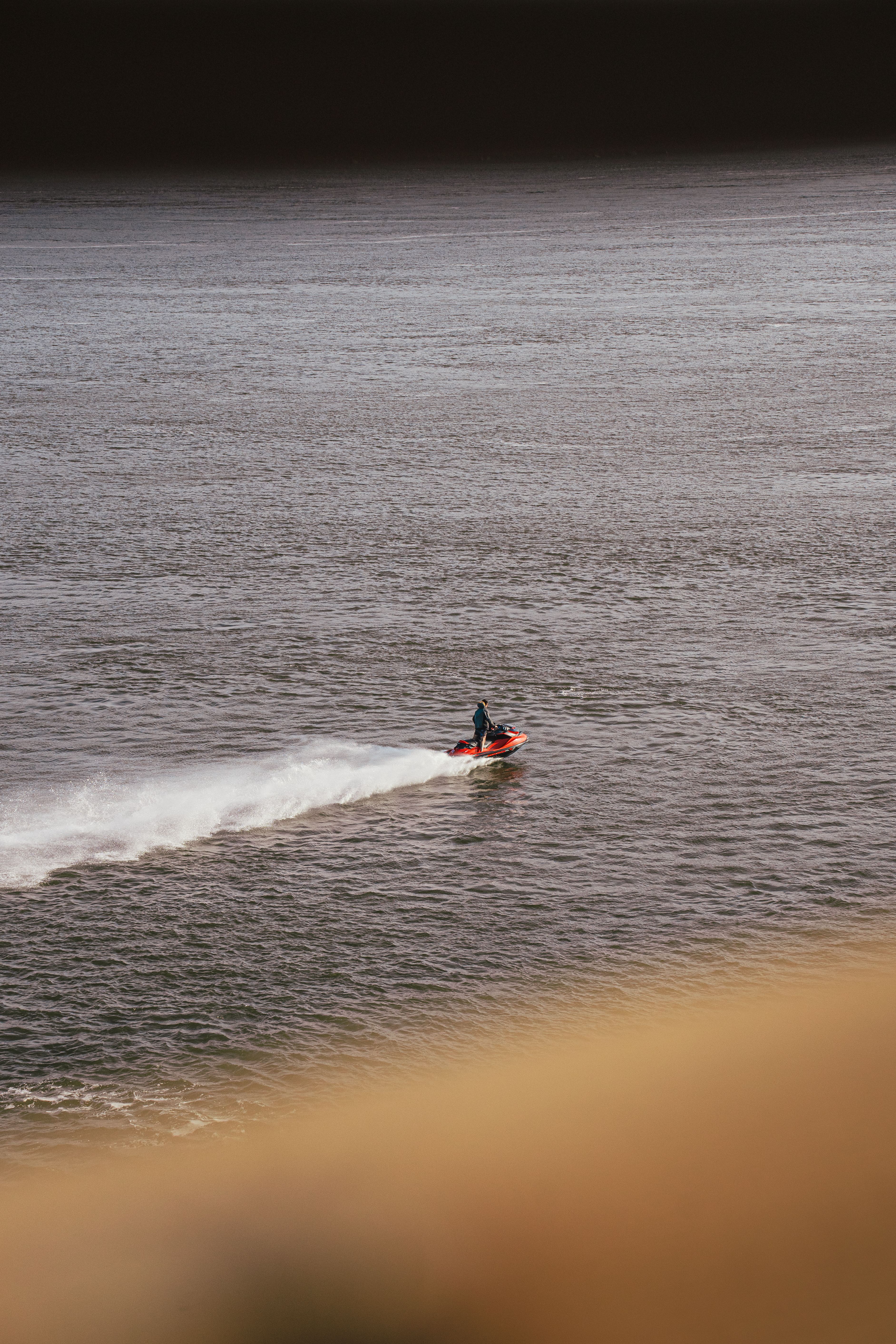 Person Riding on Orange Water Scooter · Free Stock Photo