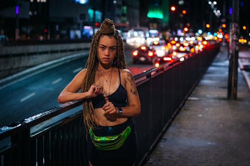 Woman Leaning On Road Railings During Nighttime