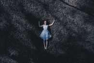 Woman Laying Down On Ground