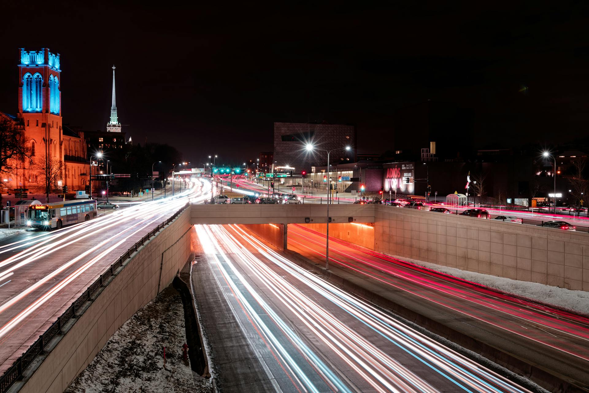 Dynamic long-exposure shot of illuminated city streets in Minneapolis at night.