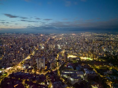 Captivating aerial cityscape of Belo Horizonte, Brazil at dusk, showcasing urban lights and skyline.