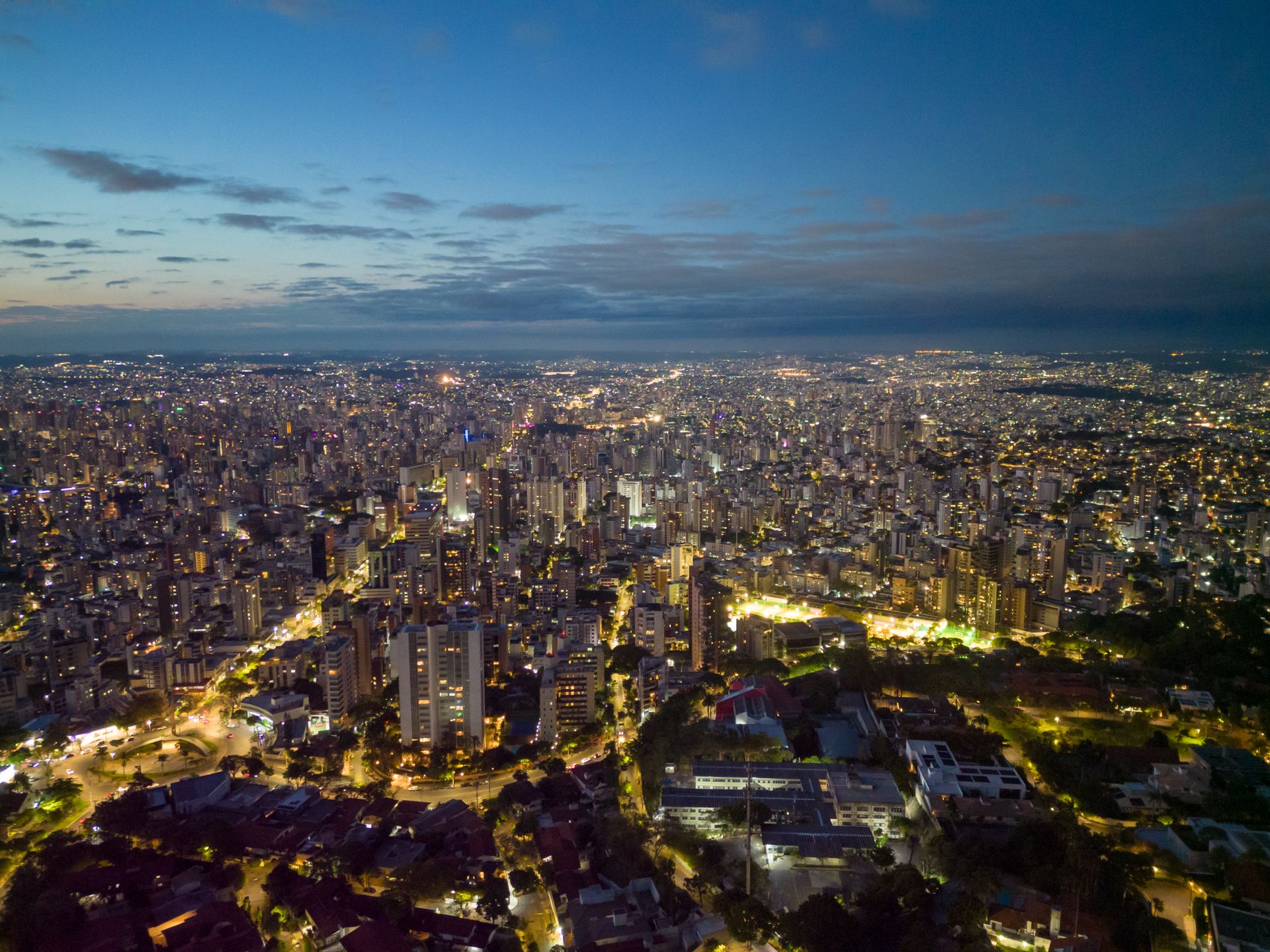 Captivating aerial cityscape of Belo Horizonte, Brazil at dusk, showcasing urban lights and skyline.