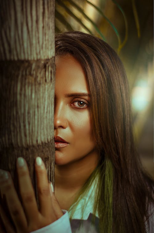 Woman Face behind Tree