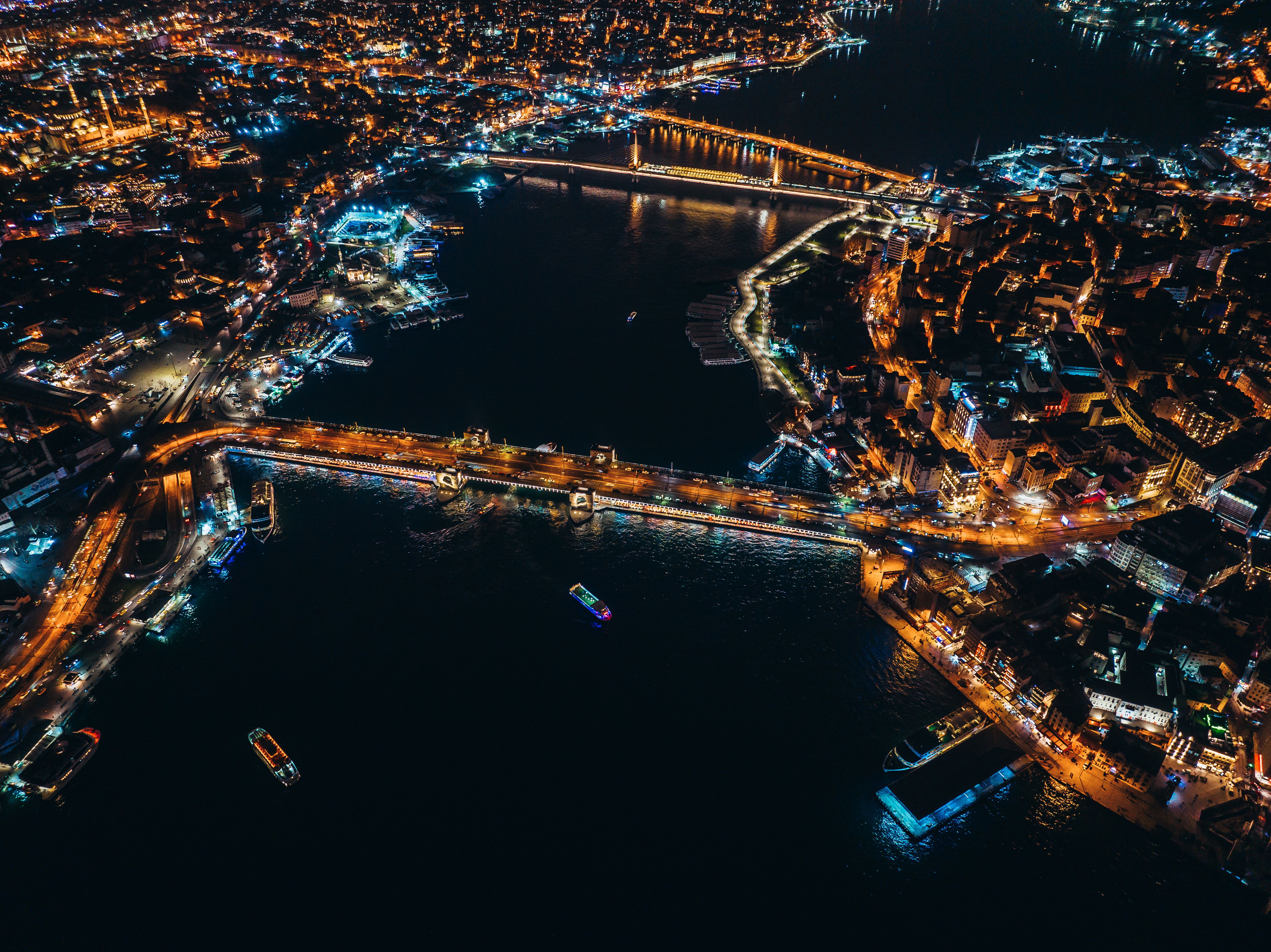 Aerial View of an Illuminated City and a River at Night · Free Stock Photo