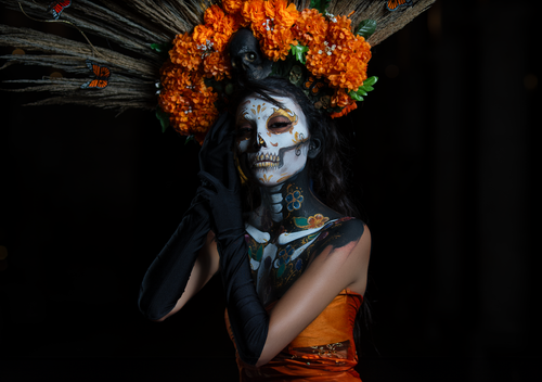 Free A striking portrait of a woman in Día de los Muertos makeup and floral headpiece in Morelia, Mexico. Stock Photo