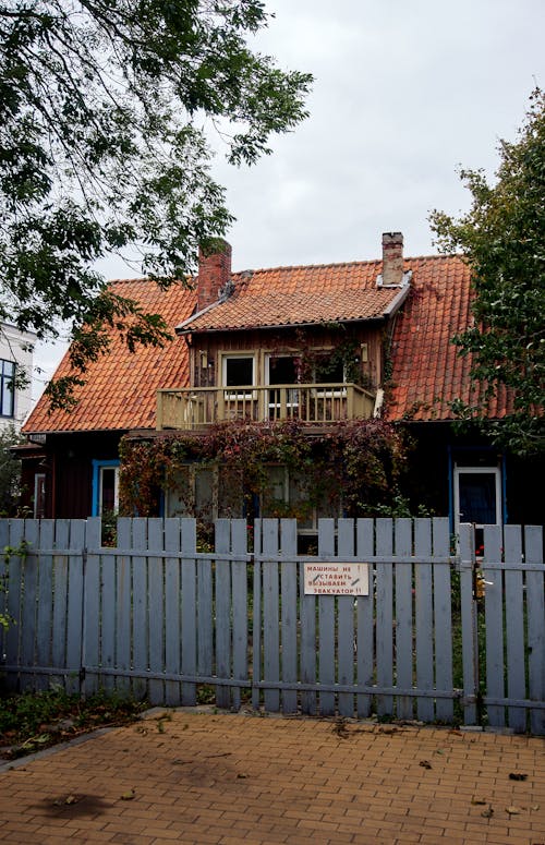 A Rustic House behind a Fence 