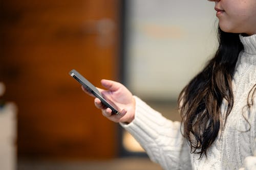 Woman Holding Apple Iphone in Hand