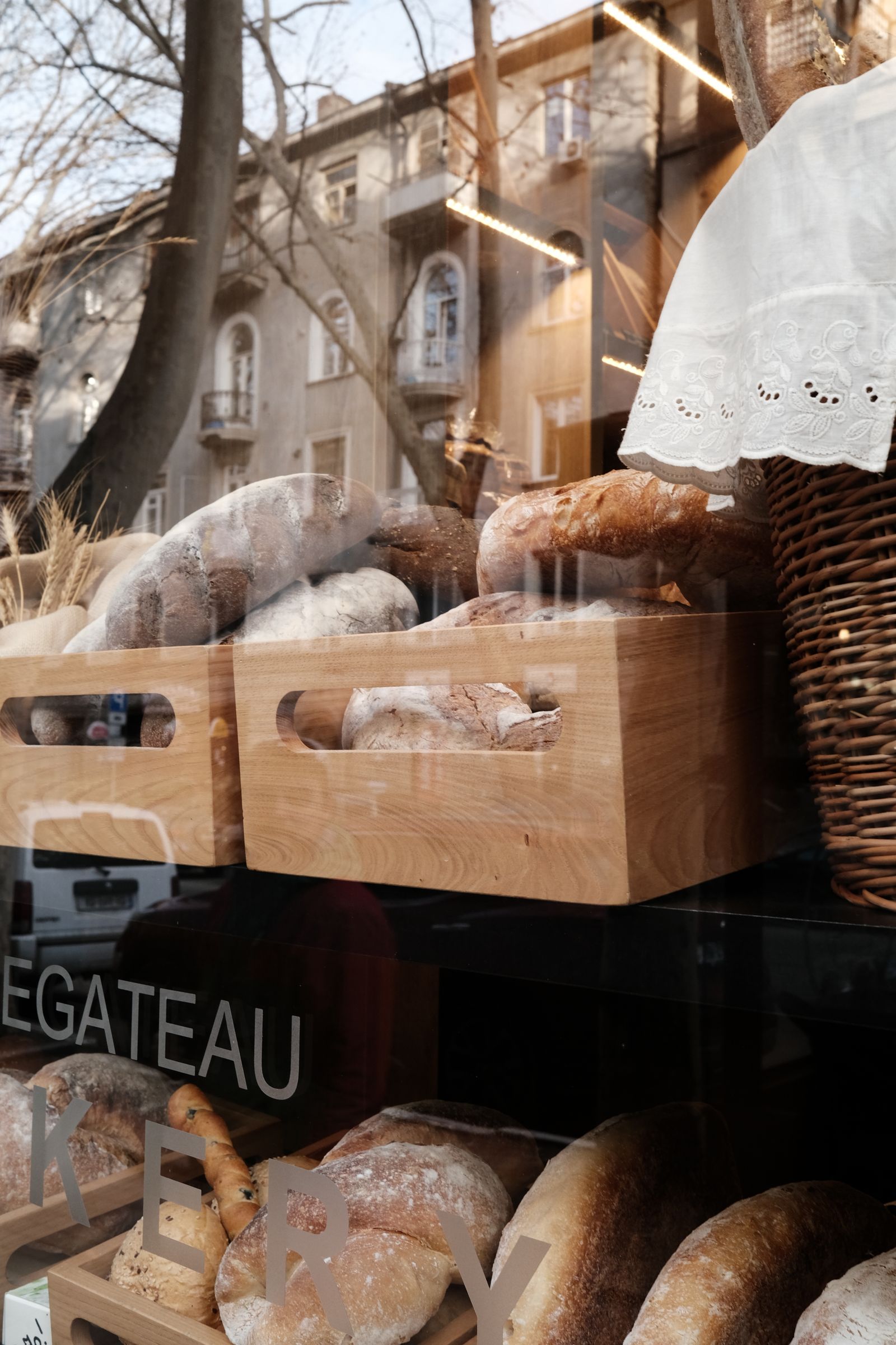 Freshly baked bread resting in baskets in the bakery window