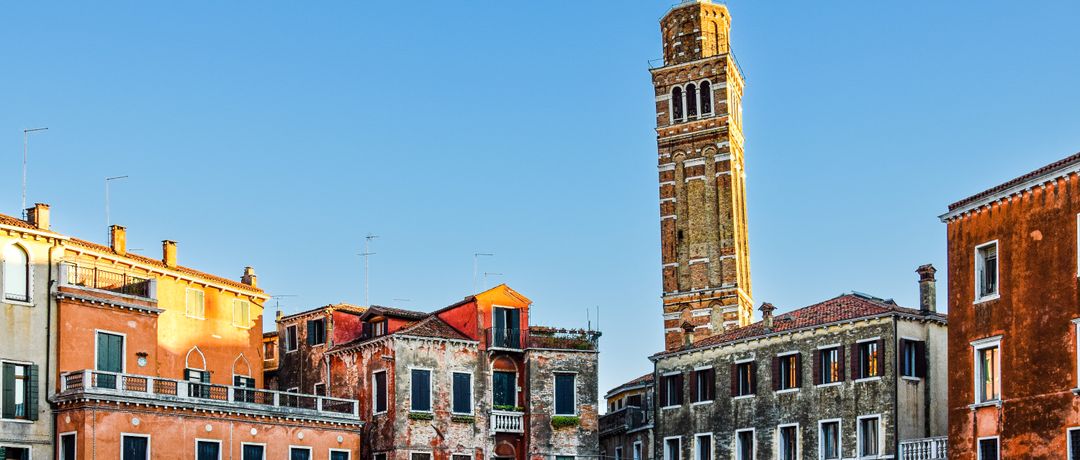 Charming Venetian buildings and tower in warm sunlight creating classic cityscape., Venice, Italy, stay connected here with a travel eSIM