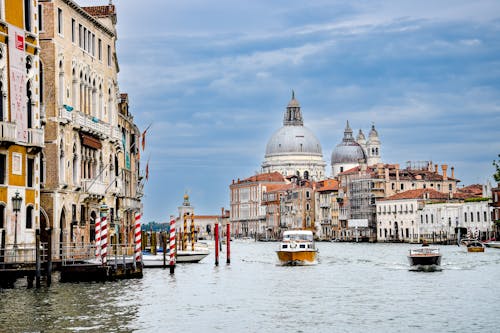 View of Houses, Boats and the Santa Maria della Salute Church from the Grand Canal in Venice, Italy 