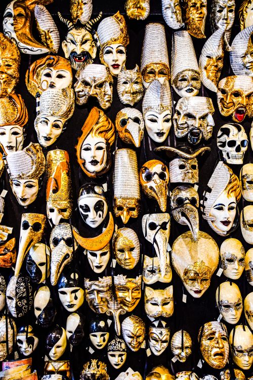 Free Vibrant display of assorted Venetian masks including plague doctor designs. Stock Photo