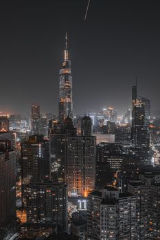 A breathtaking aerial view of a vibrant cityscape at night showcasing modern skyscrapers with a glowing skyline.
