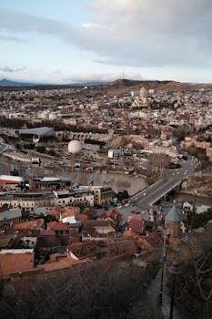 A stunning panoramic view of Tbilisi, Georgia, showcasing historic architecture and vibrant city life.