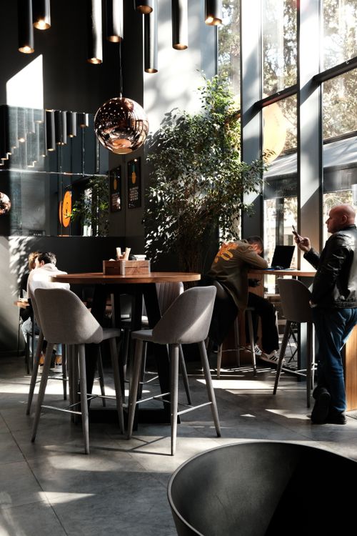 Free Sunlit modern café in Tbilisi with stylish furniture and relaxed atmosphere. Stock Photo
