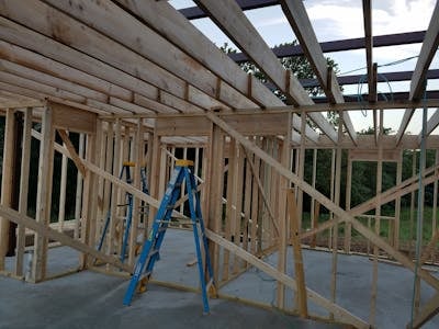 Residential basement framing with wood studs and ladder