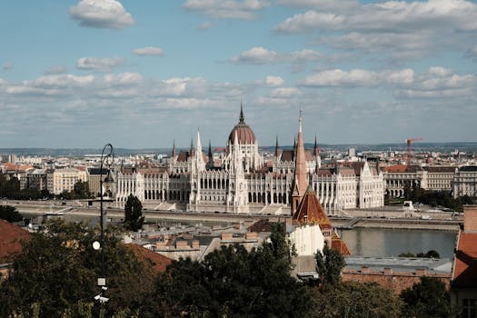 Discover the stunning architecture of the Budapest Parliament nestled by the Danube River.
