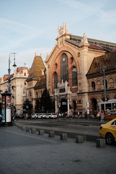 Stunning view of Budapest's Great Market Hall, showcasing its iconic architecture and bustling street.