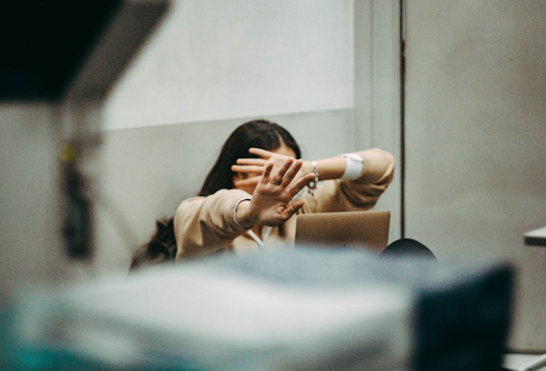 Woman Hiding her Friends with her Hands 