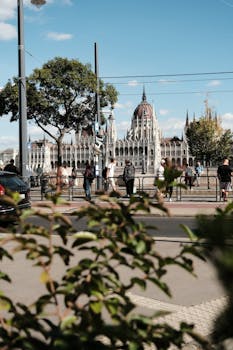 Capture of Budapest Parliament with Danube River and people in foreground.