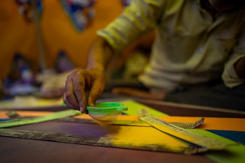 Man Sieving Yellow Powder