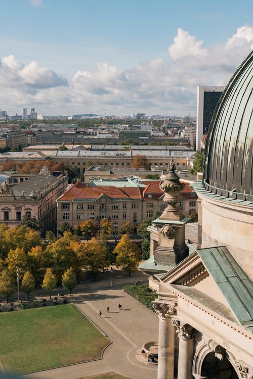 Free Aerial view of Berlin cityscape showcasing rooftops and the iconic cathedral. Stock Photo