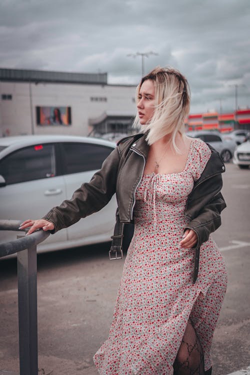 Blonde Woman in Jacket and Sundress on Parking Lot
