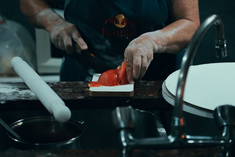 Person Slicing Tomato