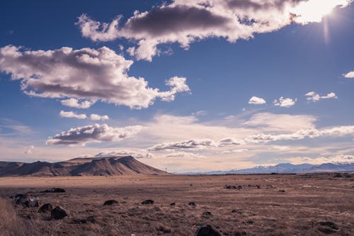 Brown Cliff Under White and Blue Sky