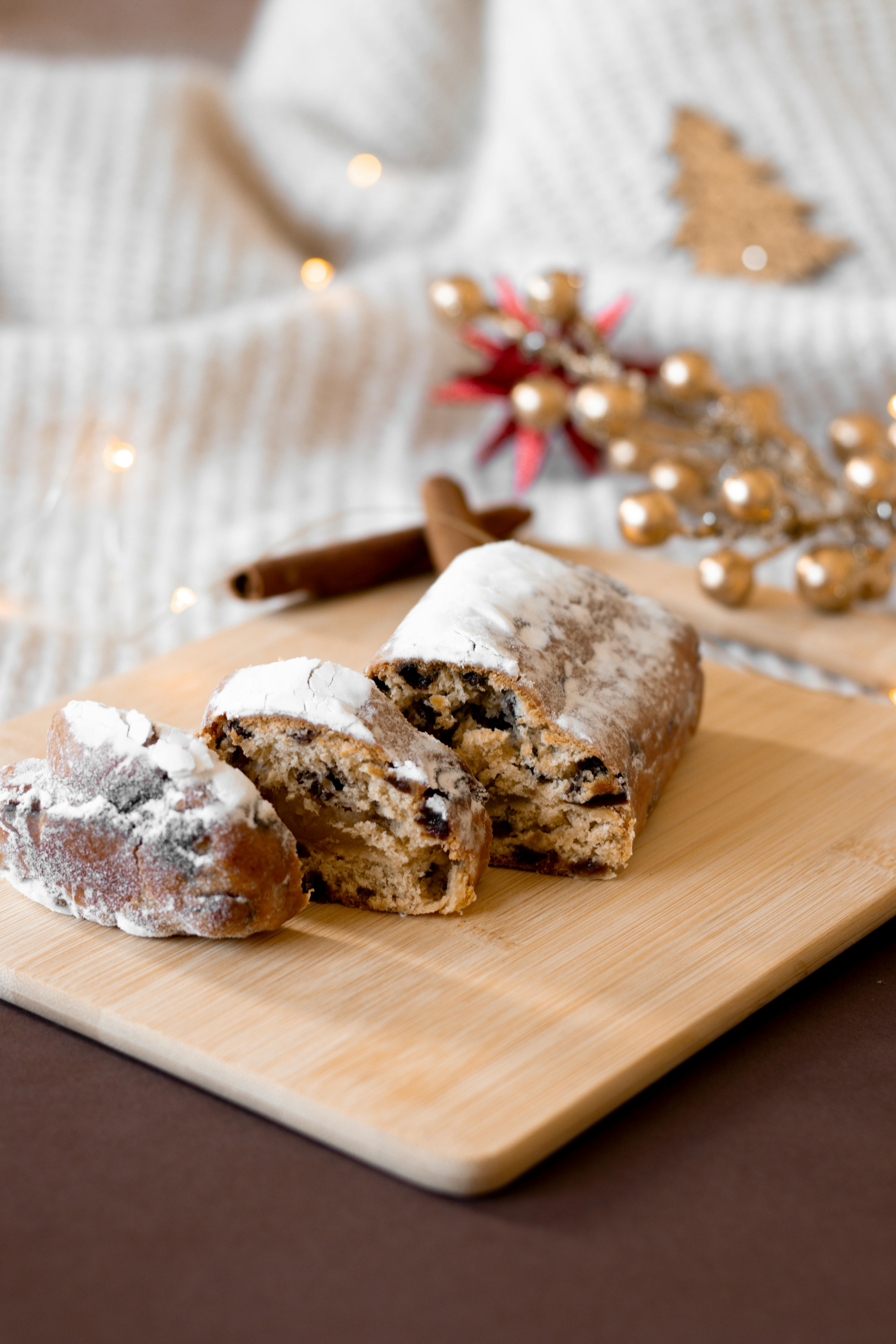 Festive fruitcake on a wooden board with holiday decor, perfect for celebrations.
