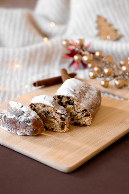 Festive fruitcake on a wooden board with holiday decor, perfect for celebrations.