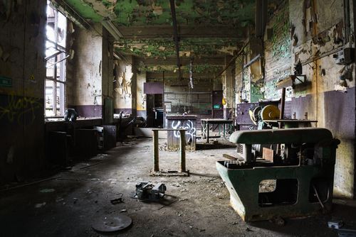 Free Rustic abandoned factory with peeling paint and old machinery. Stock Photo