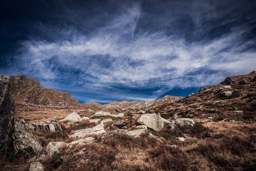 Free Beautiful barren landscape with rugged mountains and dramatic clouds. Stock Photo
