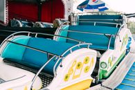 Brightly colored seats on an amusement park ride, perfect for capturing nostalgia and fun.