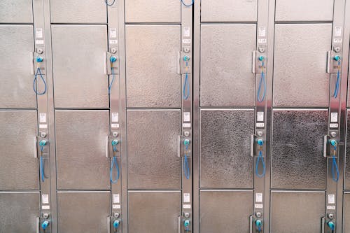 Rows of Shiny Metal Lockers with Blue Keys