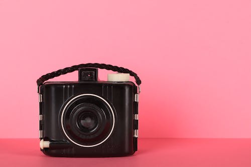 Black Camera On Pink Surface