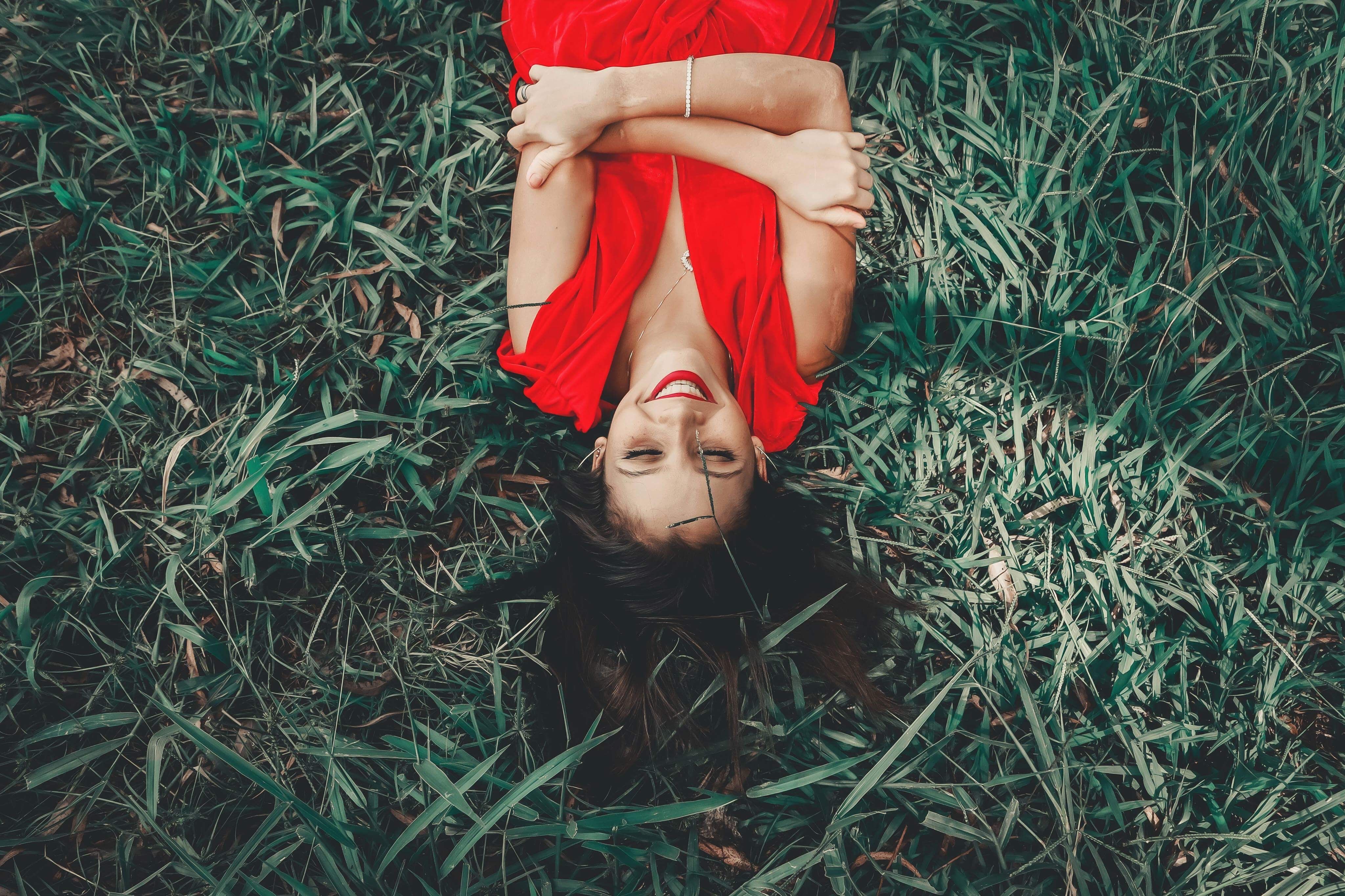 Woman Laying On Green Grass Field · Free Stock Photo