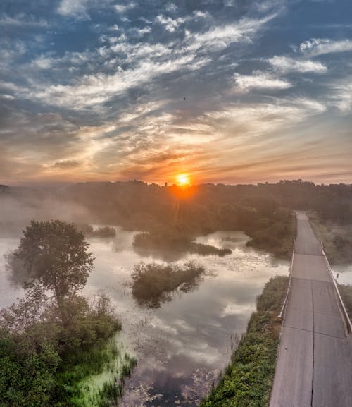 View of a Body of Water and Bridge at Sunrise