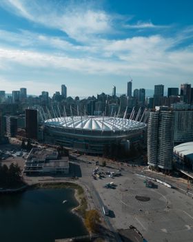 A stunning aerial view of BC Place amidst Vancouver's modern cityscape, showcasing urban architecture.