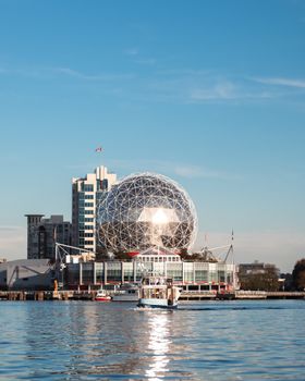 Stunning view of the Science World building reflecting on the water in Vancouver, Canada.