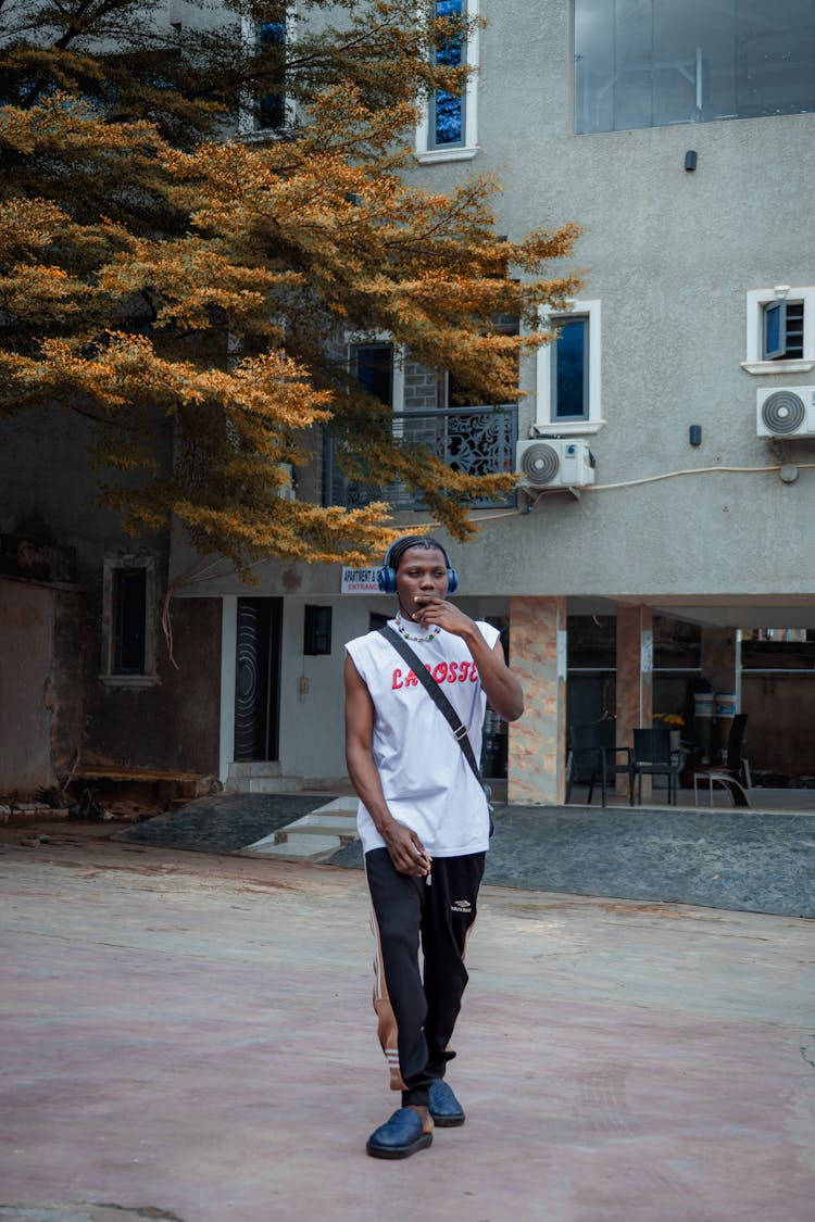 Young Man In A Trendy Casual Outfit Standing Outside