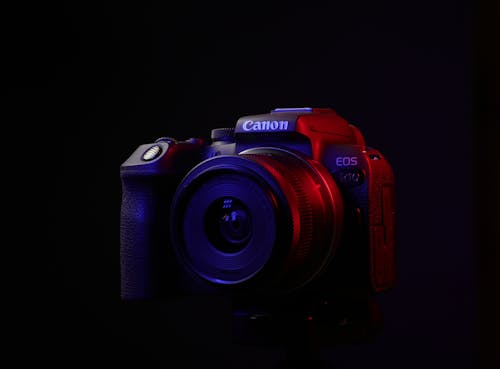 A Canon EOS SLR Camera against Black Background 