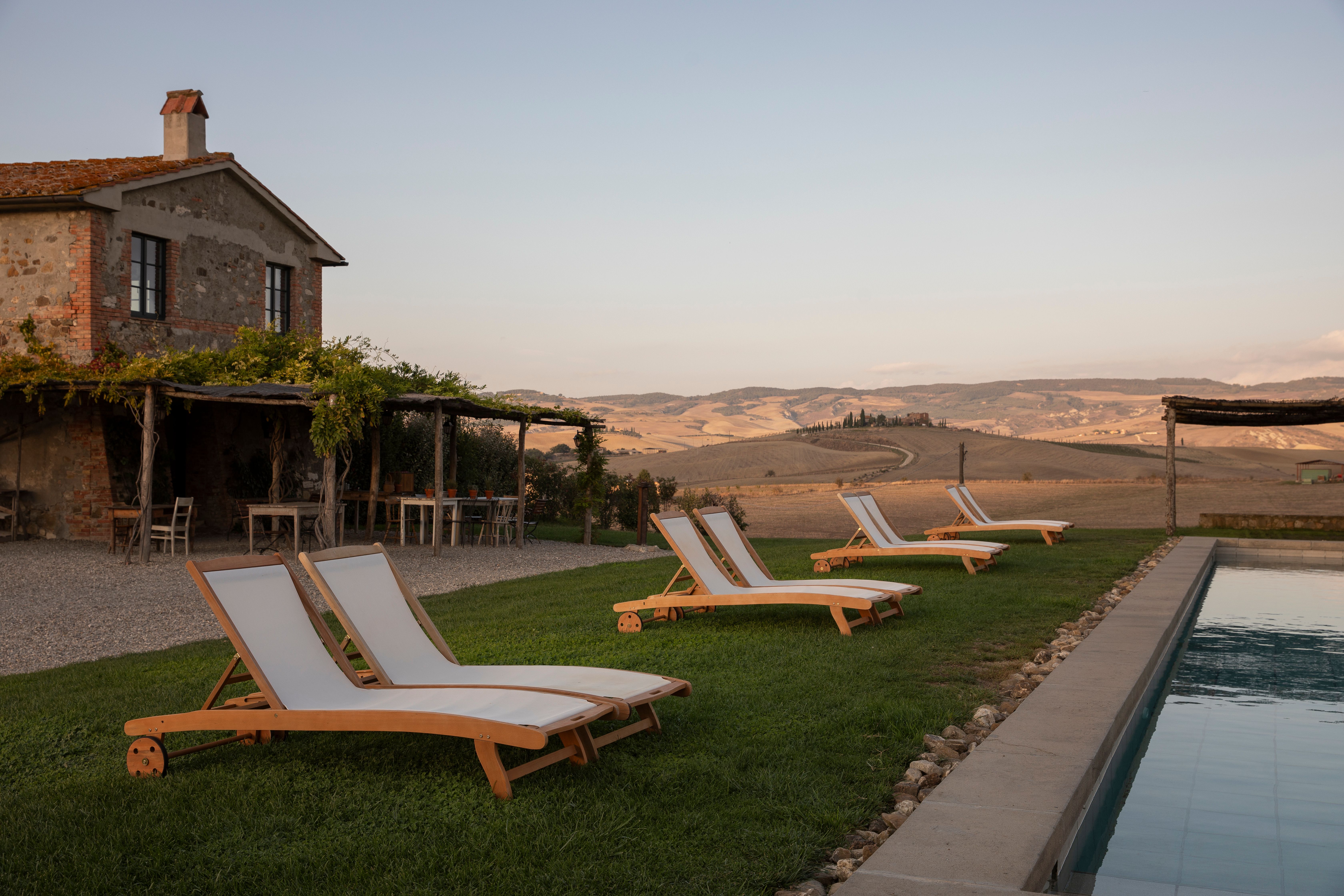 Shaded terrace of a private villa overlooking estate vine rows