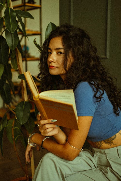Young Woman Holding an Open Book